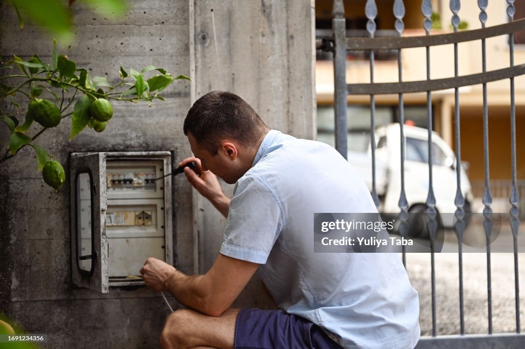 Man repairing an electric fence.