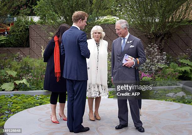 Britain's Prince Harry speaks with his father Prince Charles and wife Camilla, Duchess of Cornwall, as they visit his Forget-me-not garden, which is...
