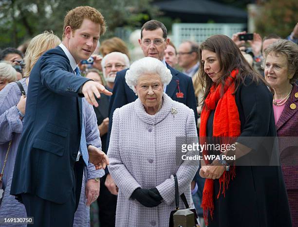 Queen Elizabeth II and Prince Harry visit the Sentebale Forget-me-not garden the Chelsea Flower Show press and VIP preview day at Royal Hospital...
