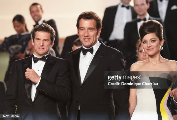 Director Guillaume Canet, actor Clive Owen and actress Marion Cotillard leave the Premiere of 'Blood Ties' during the 66th Annual Cannes Film...