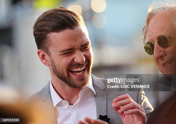 Actor and singer Justin Timberlake laughs on May 20, 2013 with musician and producer T Bone Burnet as they take part in the show "Le Grand Journal"...