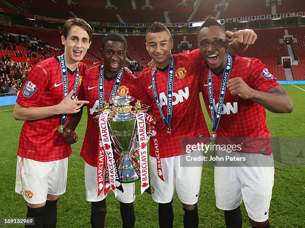 Adnan Januzaj, Larnell Cole, Jesse Lingard and Charni Ekangamene of Manchester United U21s pose with the Barclays U21 Elite Group trophy after the...