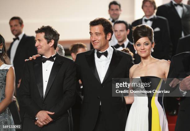 Clive Owen , director Guillaume Canet and actress Marion Cotillard leave the Premiere of 'Blood Ties' during the 66th Annual Cannes Film Festival at...