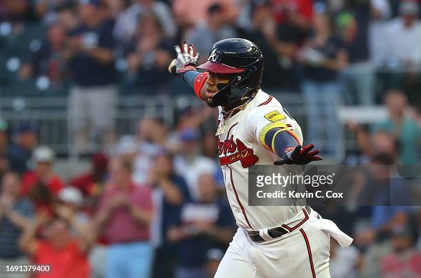 Ronald Acuna Jr. #13 of the Atlanta Braves reacts as he rounds first base after hitting a solo homer to lead off the first inning against the...