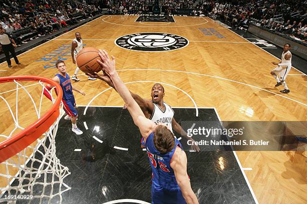 Tyshawn Taylor of the Brooklyn Nets shoots against Viacheslav Kravtsov of the Detroit Pistons on April 17, 2013 at the Barclays Center in the...