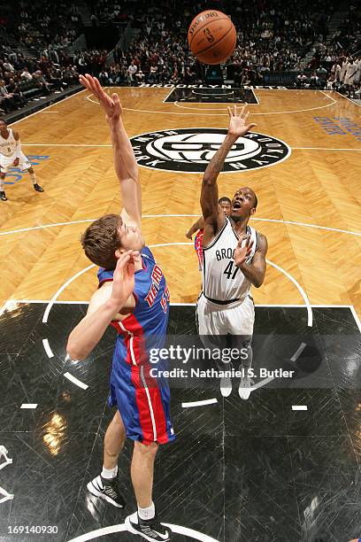 Tyshawn Taylor of the Brooklyn Nets shoots against Viacheslav Kravtsov of the Detroit Pistons on April 17, 2013 at the Barclays Center in the...