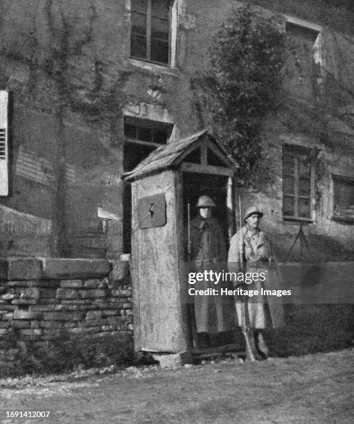 'Hours of Victory; American sentry and French sentry at the entrance to a village on the front', 1917. From "L'Album de la Guerre 1914-1919, Volume...