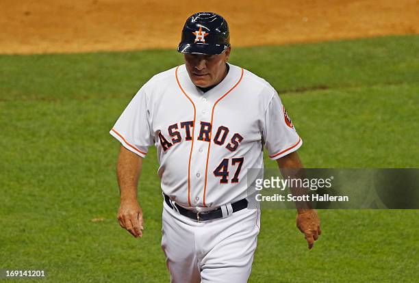 Houston Astros third base coach Dave Trembley walks to the dugout at the end of the fifth inning against the Kansas City Royals at Minute Maid Park...