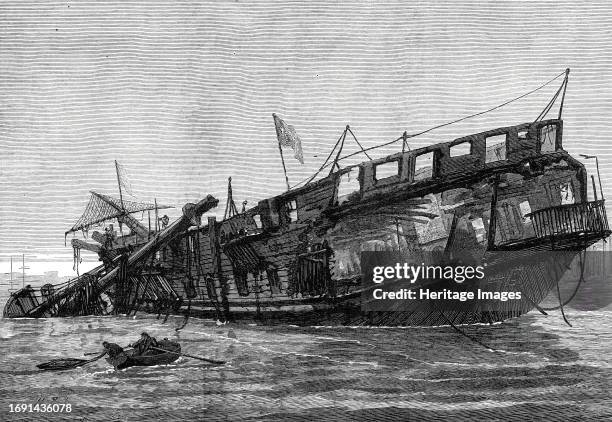 Remains of the Warspite training-ship at low tide, 1876. View of the aftermath of '...the destruction by fire...of the Warspite training-ship, lying...