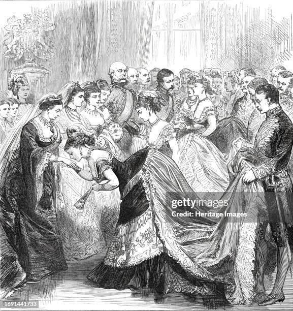 Her Majesty's Drawingroom at Buckingham Palace, 1876. The '...ceremony of personally introducing ladies to the Queen, beside whom stand their Royal...