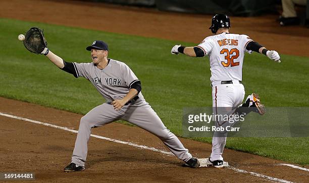 First baseman Lyle Overbay of the New York Yankees waits for the throw as Matt Wieters of the Baltimore Orioles tags the bag during the sixth inning...