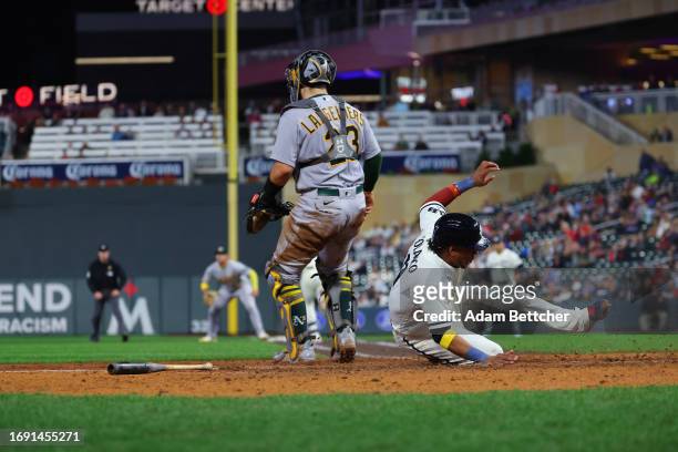 Jorge Polanco of the Minnesota Twins slides home for a run in the seventh inning against the Oakland Athletics at Target Field on September 26, 2023...