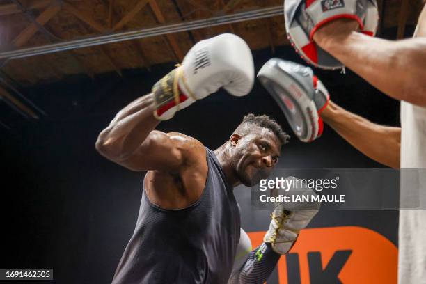 Cameroonian-French mixed martial arts star and boxer Francis Ngannou spars with John Mbumba during a training session at Ngannou's gym in Las Vegas,...