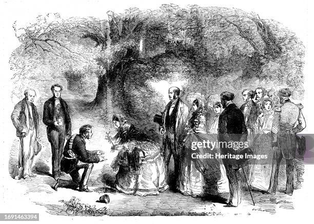 The Queen's Visit to Birmingham - Her Majesty Planting an Oak in the Grounds of Warwick Castle, 1858. 'The Queen, taking the Earl of Warwick's arm,...