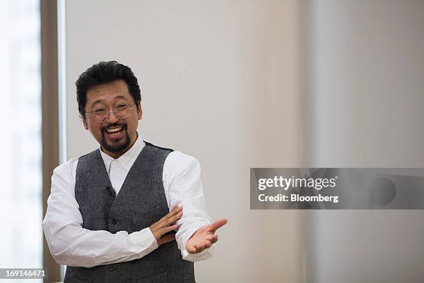 Takashi Murakami, a Japanese contemporary artist, gestures during an interview at the Galerie Perrotin in Hong Kong, China, on Monday, May 20, 2013....