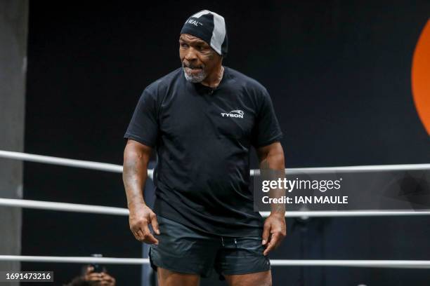 Former US boxer Mike Tyson watches a sparring session with Cameroonian-French mixed martial arts star and boxer Francis Ngannou at Ngannou's gym in...