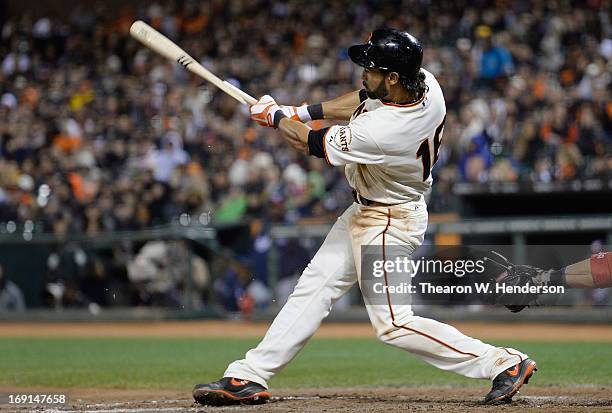 Angel Pagan of the San Francisco Giants breaks his bat hitting a base loaded two-run single against the Washington Nationals in the seventh inning at...