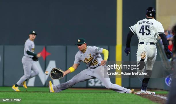 Ryan Noda of the Oakland Athletics stretches to make the out on Andrew Stevenson of the Minnesota Twins in the eighth inning at Target Field on...