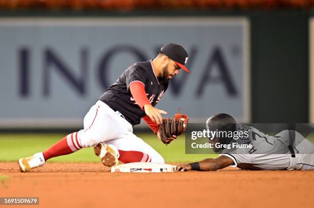 Tim Anderson of the Chicago White Sox is tagged out trying to steal second base by Luis Garcia of the Washington Nationals in the third inning at...