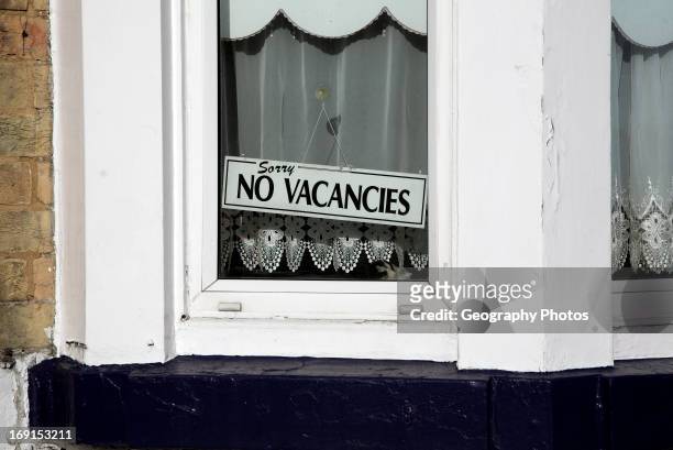 No vacancies sign in window. Seafront guest houses out of season, Lowestoft, Suffolk, England.