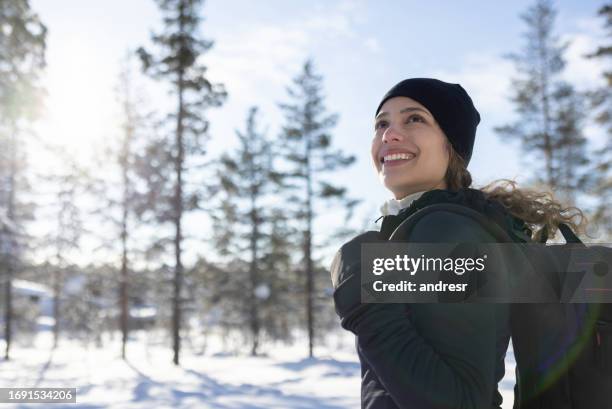 happy woman hiking outdoors in the winter - finland happy stock pictures, royalty-free photos & images
