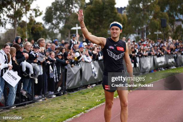 Darcy Moore of the Magpies waves to fans during a Collingwood Magpies AFL training session at Olympic Park Oval on September 20, 2023 in Melbourne,...