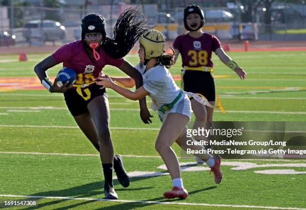Long Beach, CA Wilsons Jordyn Jefferson losing her flag to Poly during a flag football game at Wilson in Long Beach on Tuesday, September 19, 2023....
