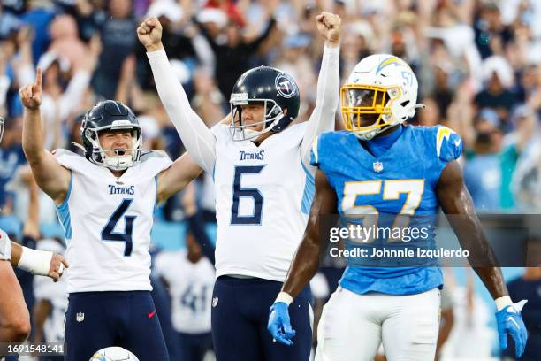 Nick Folk and Ryan Stonehouse of the Tennessee Titans celebrate after a game-winning field goal in overtime against the Los Angeles Chargers at...