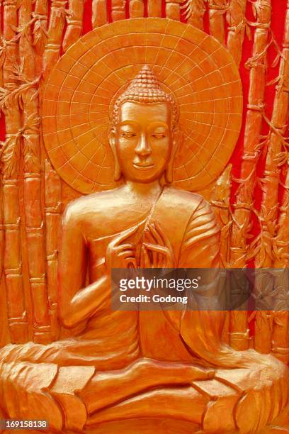Detail of Buddha sculpture in Wat Ounalom, Buddha teaching to his disciples in Veluvana bamboo forest
