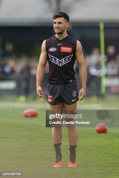 Nick Daicos of the Magpies looks on during a Collingwood Magpies AFL training session at Olympic Park Oval on September 20, 2023 in Melbourne,...