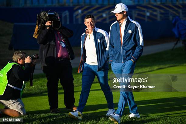 Team Europe players Rory McIlroy and Ludvig Aberg smile as they arrive for a team photo call prior to the 2023 Ryder Cup at Marco Simone Golf Club on...