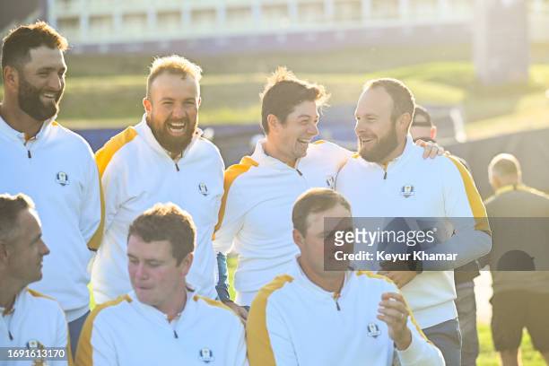 Team Europe players Jon Rahm, Shane Lowry, Viktor Hovland and Tyrrell Hatton smile during a team photo call prior to the 2023 Ryder Cup at Marco...