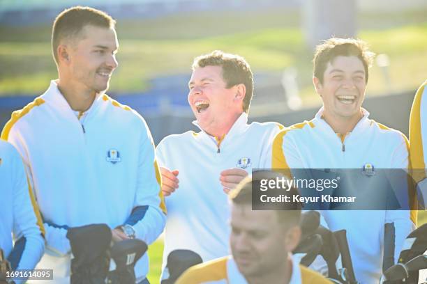 Team Europe players Nicolai Hojgaard, Robert MacIntyre and Viktor Hovland smile during a team photo call prior to the 2023 Ryder Cup at Marco Simone...