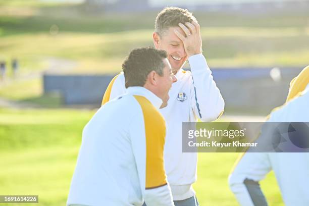 Team Europe players Rory McIlroy and Justin Rose smile during a team photo call prior to the 2023 Ryder Cup at Marco Simone Golf Club on September...