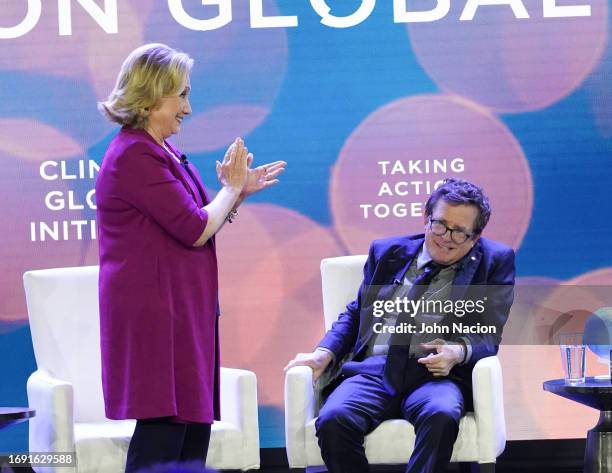 Former US Secretary of State Hillary Clinton and Michael J. Fox speak during the Clinton Global Initiative meeting at the Hilton Midtown on September...