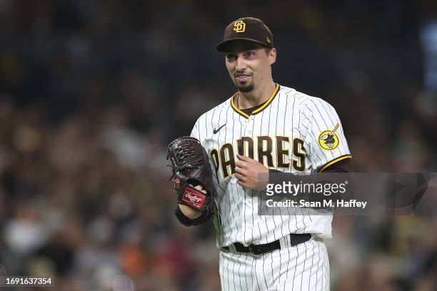 Blake Snell of the San Diego Padres reacts as he walks to the dugout after throwing seven hitless innings a game against the Colorado Rockies at...