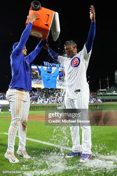 Alexander Canario of the Chicago Cubs is doused with water by Christopher Morel after the game against the Pittsburgh Pirates at Wrigley Field on...