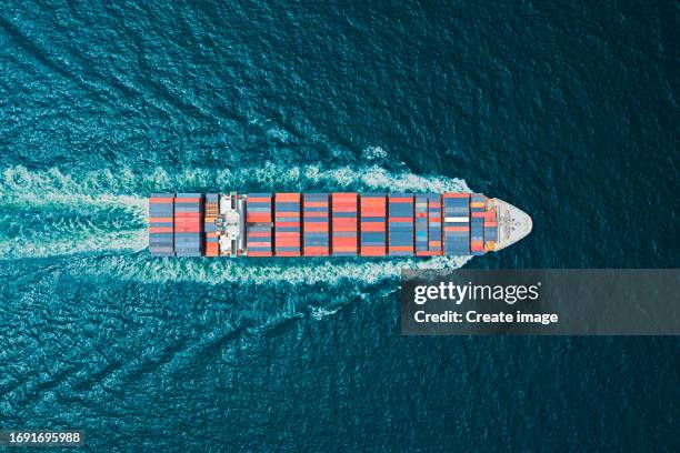 aerial top view container cargo ship full speed with beautiful wave pattern carrier container on the sea for business logistics, import export, shipping or freight transportation. - full elevator stock pictures, royalty-free photos & images