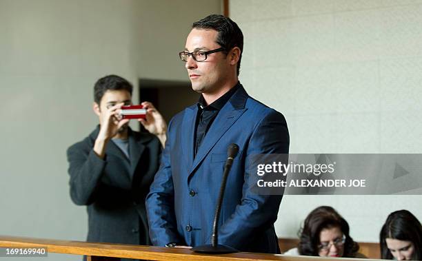 Carl Pistorius, the brother of Oscar Pistorius, waits prior to appear in court for culpable homicide of a 36-year-old woman, in a collision involving...