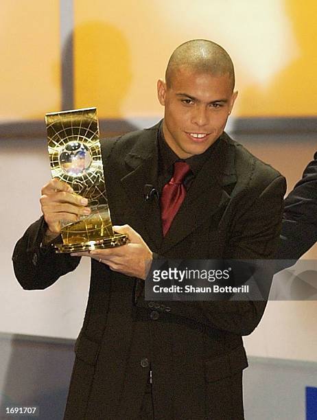 Ronaldo of Brazil holds his trophy aloft after winning the 2002 FIFA World Player Award during the 2002 FIFA World Player Gala at the Palacio de...