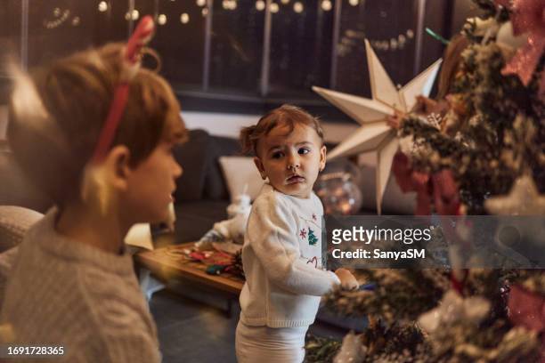 happy children decorating christmas tree - sm party bildbanksfoton och bilder