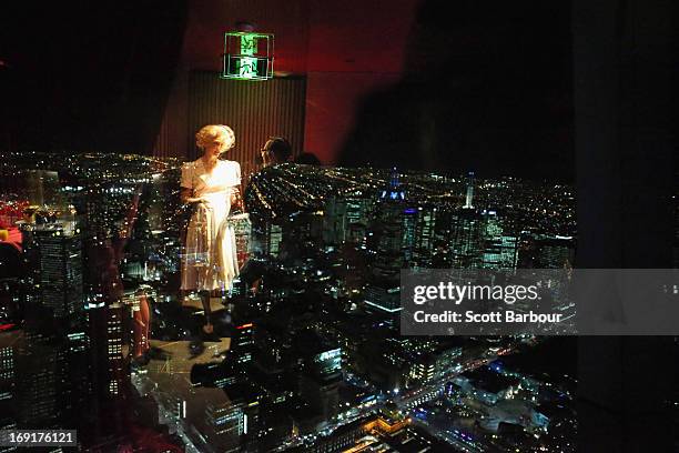 Actress and star of King Kong, Esther Hannaford is reflected in a window as she looks over the city of Melbourne during a 'King Kong' production...