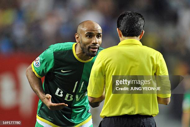 China's Beijing Guoan forward Frederic Oumar Kanoute speaks with the referee after he received a red card during their AFC Champions League Round of...