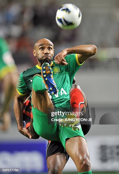 China's Beijing Guoan forward Frederic Oumar Kanoute competes for the ball with South Korea's FC Seoul defender Adilson Dos Santos during their AFC...