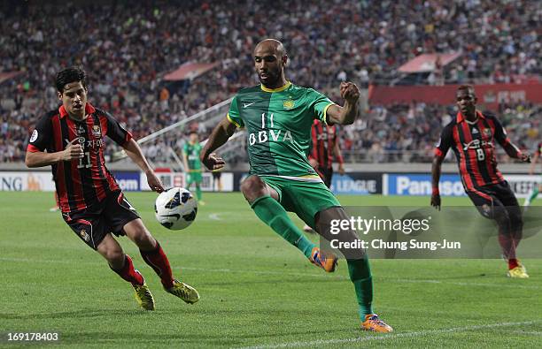 Frederic Kanoute of Beijing Go'an in action with Molina Uribe of FC Seoul during the AFC Champions League round of 16 match between FC Seoul and...