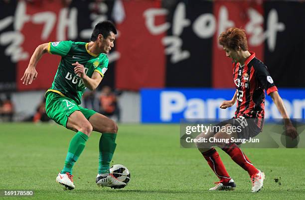 Shao Jiayi of Beijing Go'an competes for the ball with Koh Myong-Jin of FC Seoul during the AFC Champions League round of 16 match between FC Seoul...