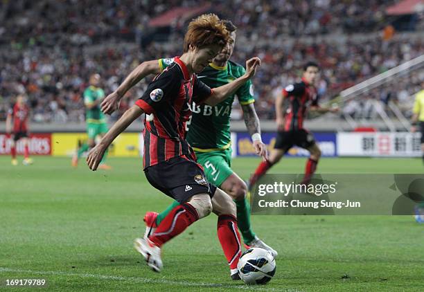 Koh Myong-Jin of FC Seoul in action with Darko Matic of Beijing Go'an during the AFC Champions League round of 16 match between FC Seoul and Beijing...