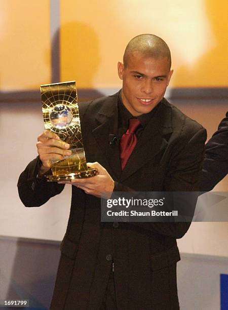 Ronaldo of Brazil holds his trophy aloft after winning the 2002 FIFA World Player Award during the 2002 FIFA World Player Gala at the Palacio de...