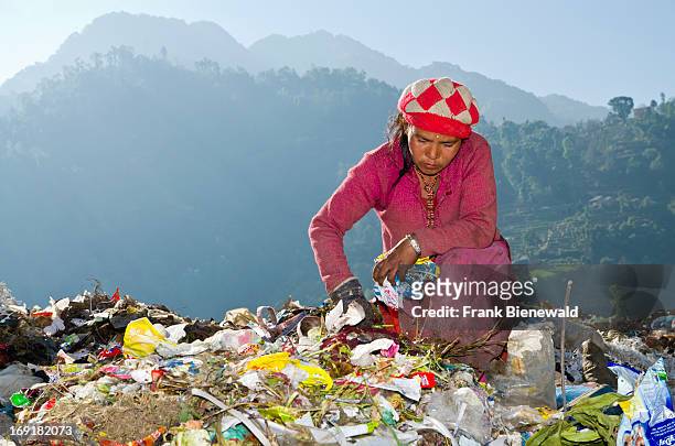 Woman sorting out garbage at Aletar garbage dump. The garbage collected off the streets of the capital city is mostly sorted for recycling by...
