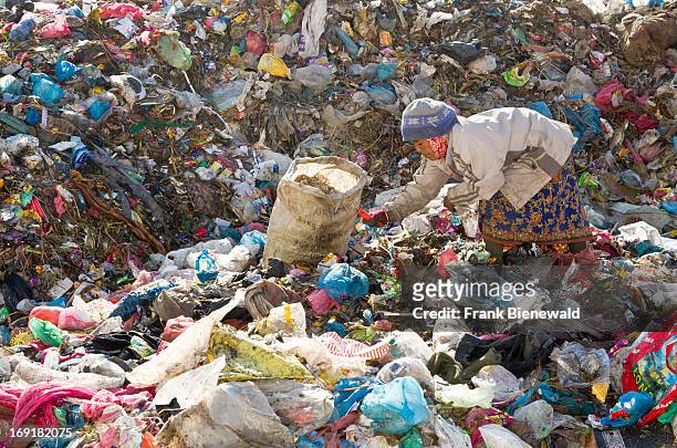 Woman sorting out garbage at Aletar garbage dump. The garbage collected off the streets of the capital city is mostly sorted for recycling by...